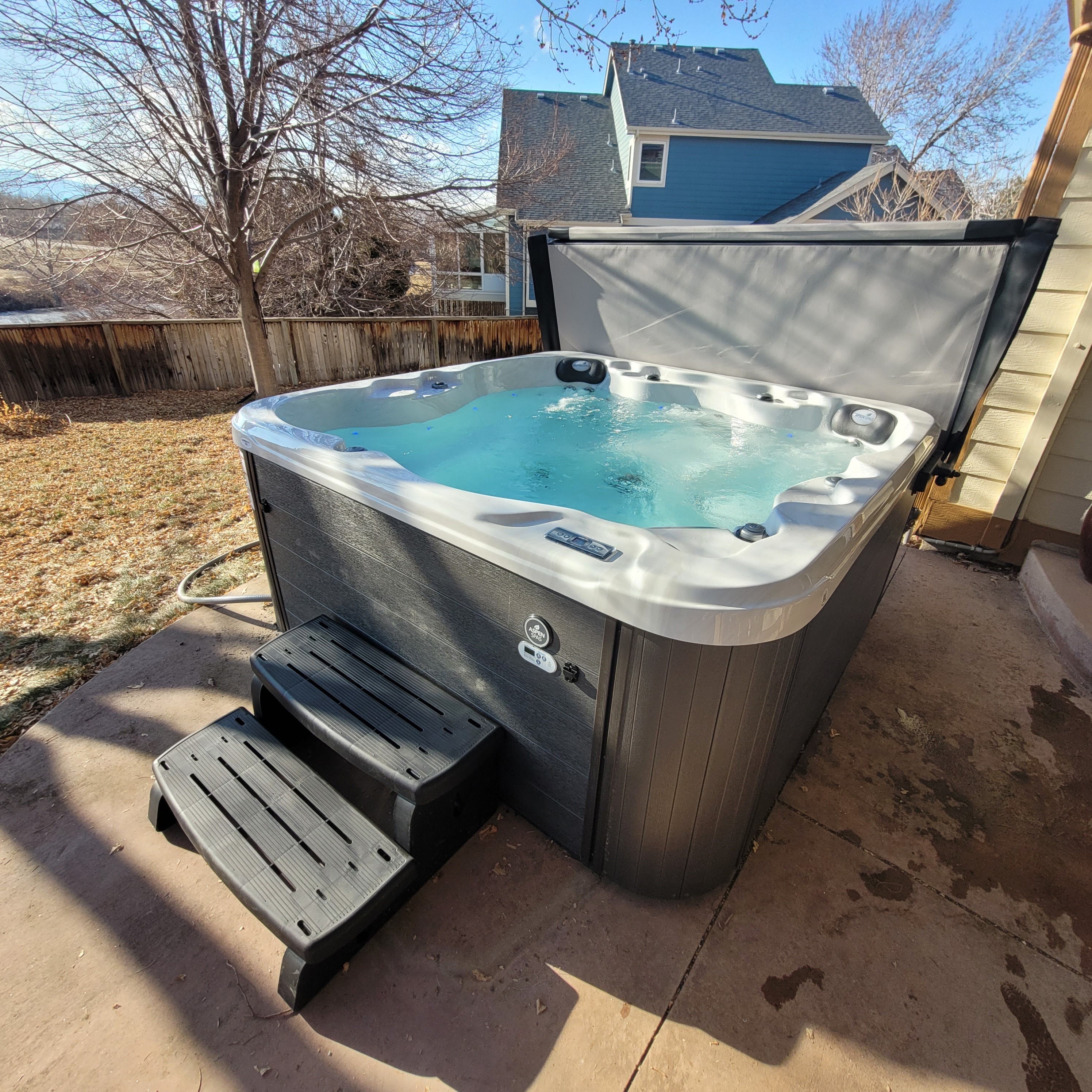 Luxury hot tub on a deck with Colorado mountain views at dusk